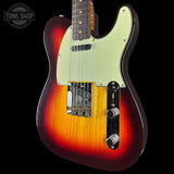 Electric guitar with a sunburst finish on a black background, featuring the Tone Shop logo.