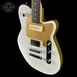 White electric guitar with gold pickguard on a black background, featuring 'Tone Shop' logo.