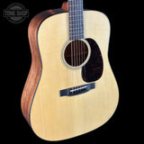 Acoustic guitar with a visible brand logo on a black background