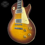 Electric guitar with a sunburst finish on a black background, featuring the Tone Shop logo.