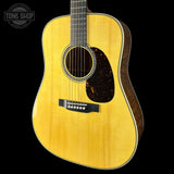 Acoustic guitar with a visible brand logo on a black background