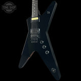 Black electric guitar on a black background with 'Tone Shop' logo.