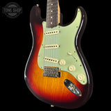 Electric guitar with a sunburst finish on a black background, featuring the Tone Shop logo.