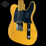 Yellow electric guitar with a black pickguard on a black background, featuring 'Tone Shop' logo.