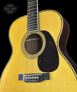 Acoustic guitar with a visible brand logo in the corner