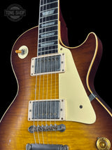 Electric guitar with a sunburst finish on a black background, featuring the Tone Shop logo.