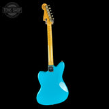 Blue electric guitar with a wooden neck on a black background, featuring 'Tone Shop' logo.