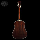 Back view of a wooden acoustic guitar on a black background with 'Tone Shop' logo.