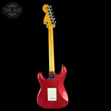 Red electric guitar with a black background