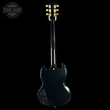 Black electric guitar with a 'Tone Shop' logo in the corner
