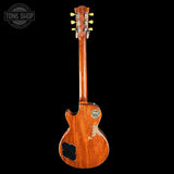 Back view of a wooden electric guitar with a visible brand logo on a black background.