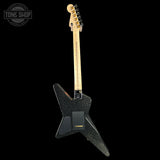 Black electric guitar with a visible brand logo on a black background
