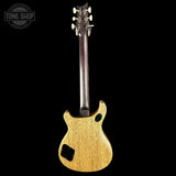 Back view of a guitar with a 'Tone Shop' logo in the corner.
