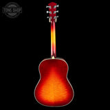 Acoustic guitar with a sunburst finish on a black background, featuring the Tone Shop logo.
