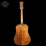 Back view of a wooden acoustic guitar with 'Tone Shop' logo in the corner.
