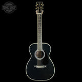 Black acoustic guitar on a white background with 'Tone Shop' logo.