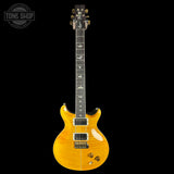 Electric guitar with a clear finish on a black background, featuring the Tone Shop logo.