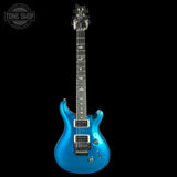 Blue electric guitar on a black background with 'Tone Shop' logo.