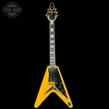 Yellow electric guitar with black accents on a white background, featuring 'Tone Shop' logo.
