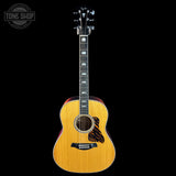 Acoustic guitar with a visible brand logo on a black background