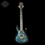 Blue electric guitar on a black background with 'Tone Shop' logo.
