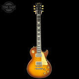 Electric guitar with a sunburst finish on a black background, featuring the Gibson logo.
