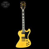 Yellow electric guitar on a black background with 'Tone Shop' logo.