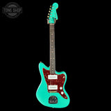 Turquoise electric guitar with a red pickguard on a black background, featuring 'Tone Shop' logo.