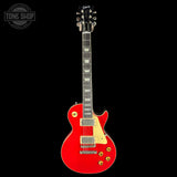 Red electric guitar with a Gibson logo on a black background