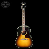 Acoustic guitar with a sunburst finish on a black background, featuring the Gibson logo.