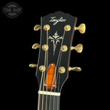 Taylor guitar headstock with brand logo on a black background