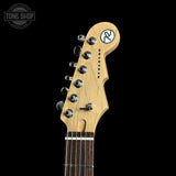 Guitar headstock with brand logo on a black background