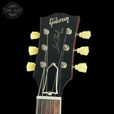 Gibson Les Paul guitar headstock with brand name on a black background