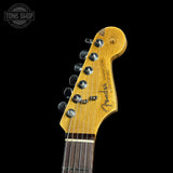 Close-up of a Fender guitar headstock on a black background with 'Tone Shop' logo.