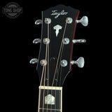 Taylor guitar headstock with brand logo on a black background