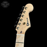 Guitar headstock with brand logo on a black background