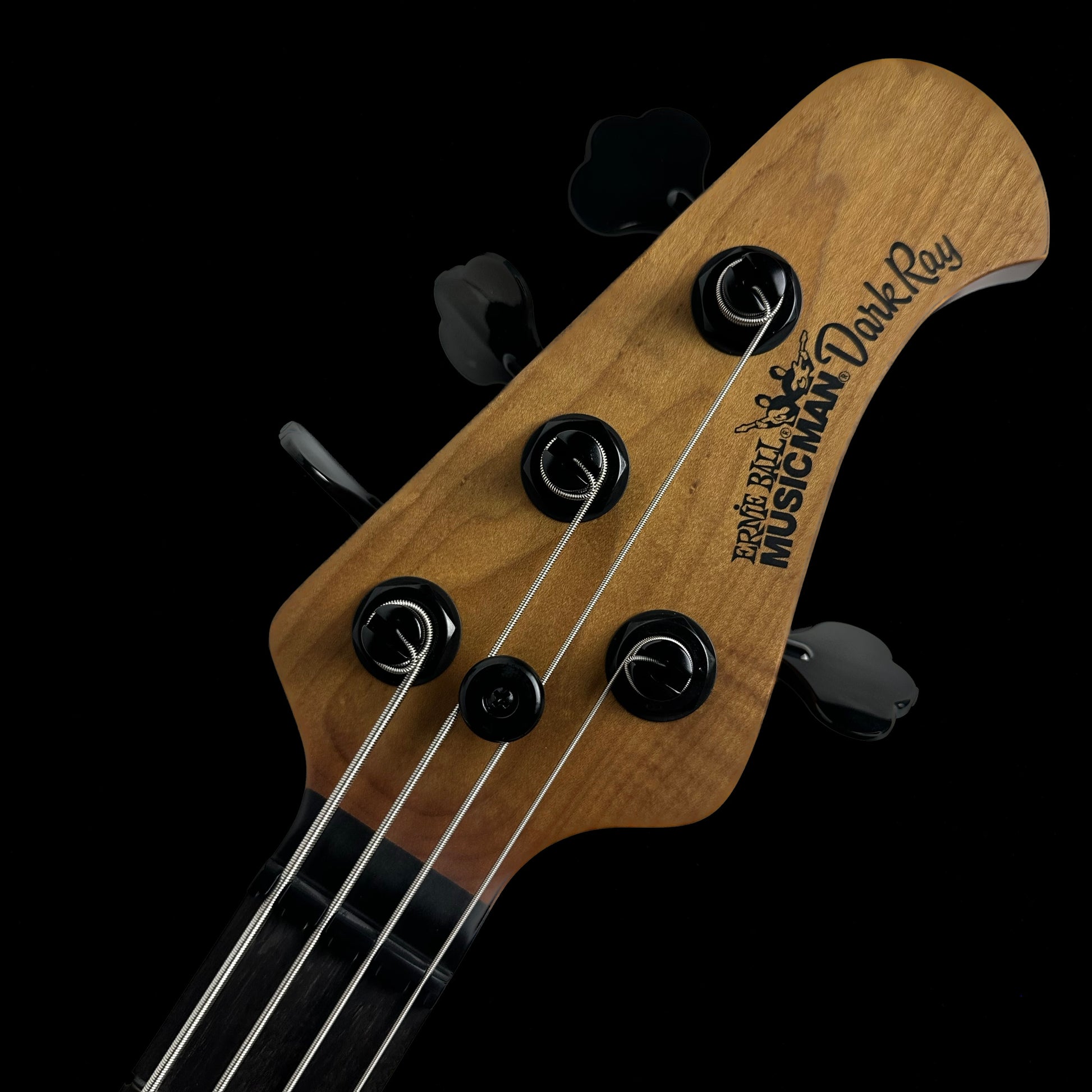 Close up of Ernie Ball Music Man DarkRay Bass Starry Night headstock.