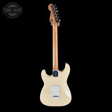 White electric guitar with a visible brand logo on a black background