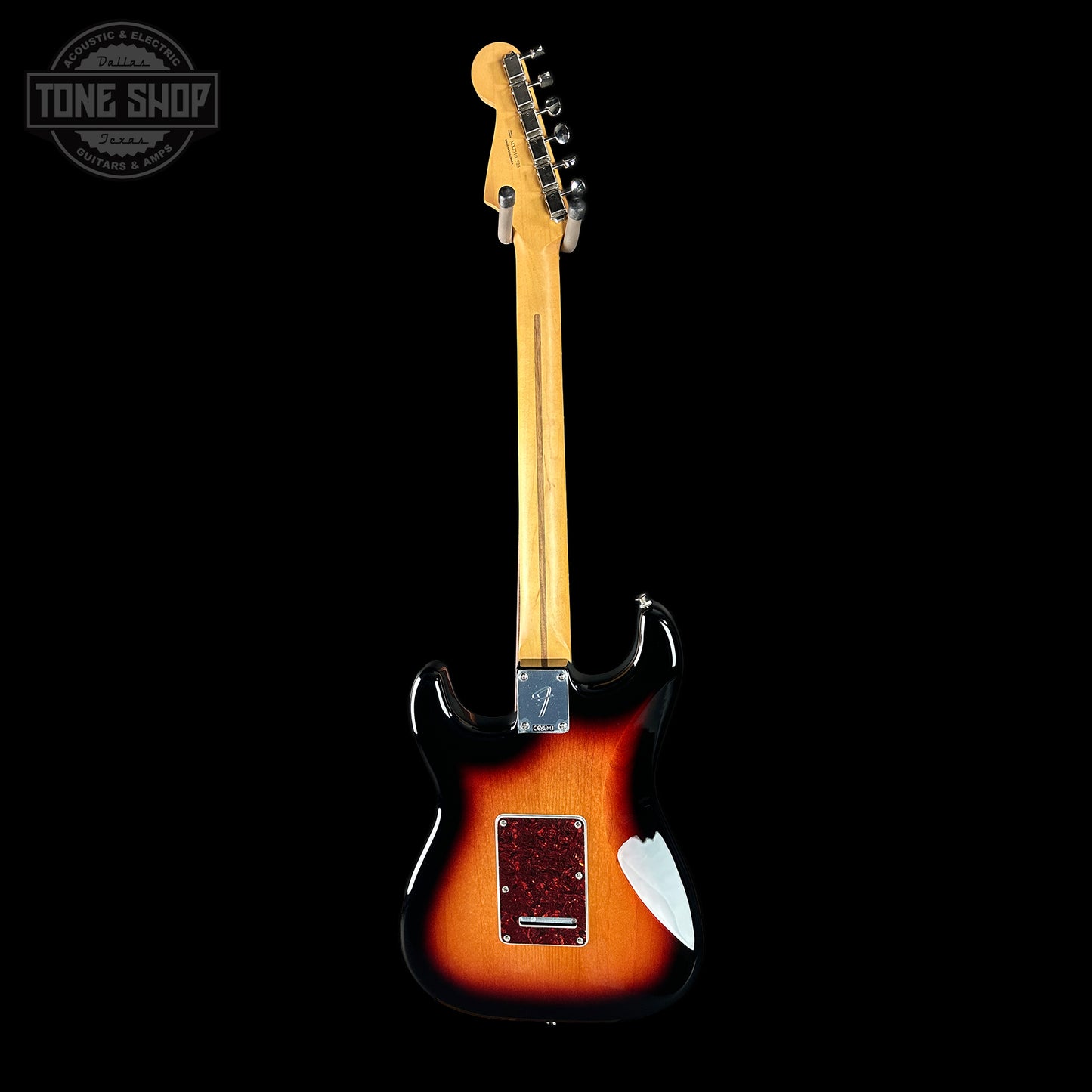 Electric guitar with a sunburst finish on a black background, featuring the Tone Shop logo.
