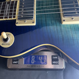Used 2002 Epiphone Les Paul Blueberry Burst MIK on scale displaying weight.