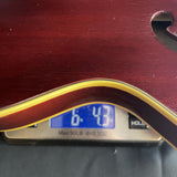 Vintage 1968 Guild Starfire III Red on scale displaying weight.