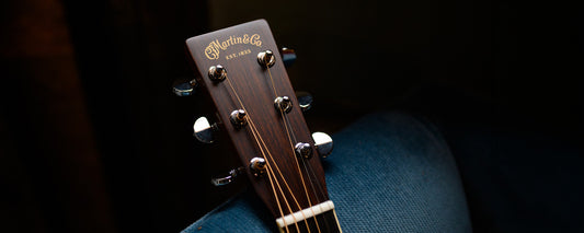 Martin Guitars headstock on a black background. 