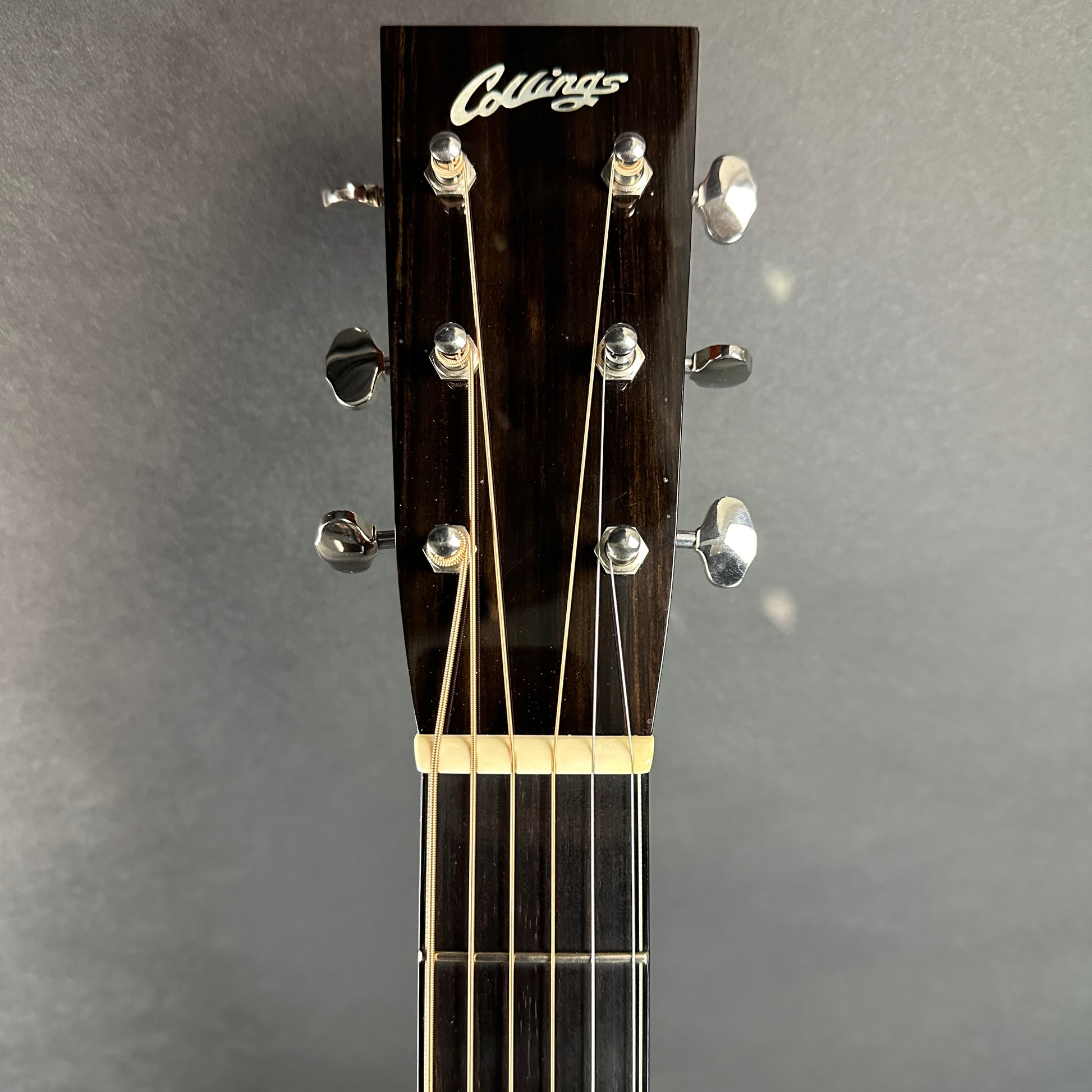 Front of headstock of Used 2005 Collings CW Mh A Natural.