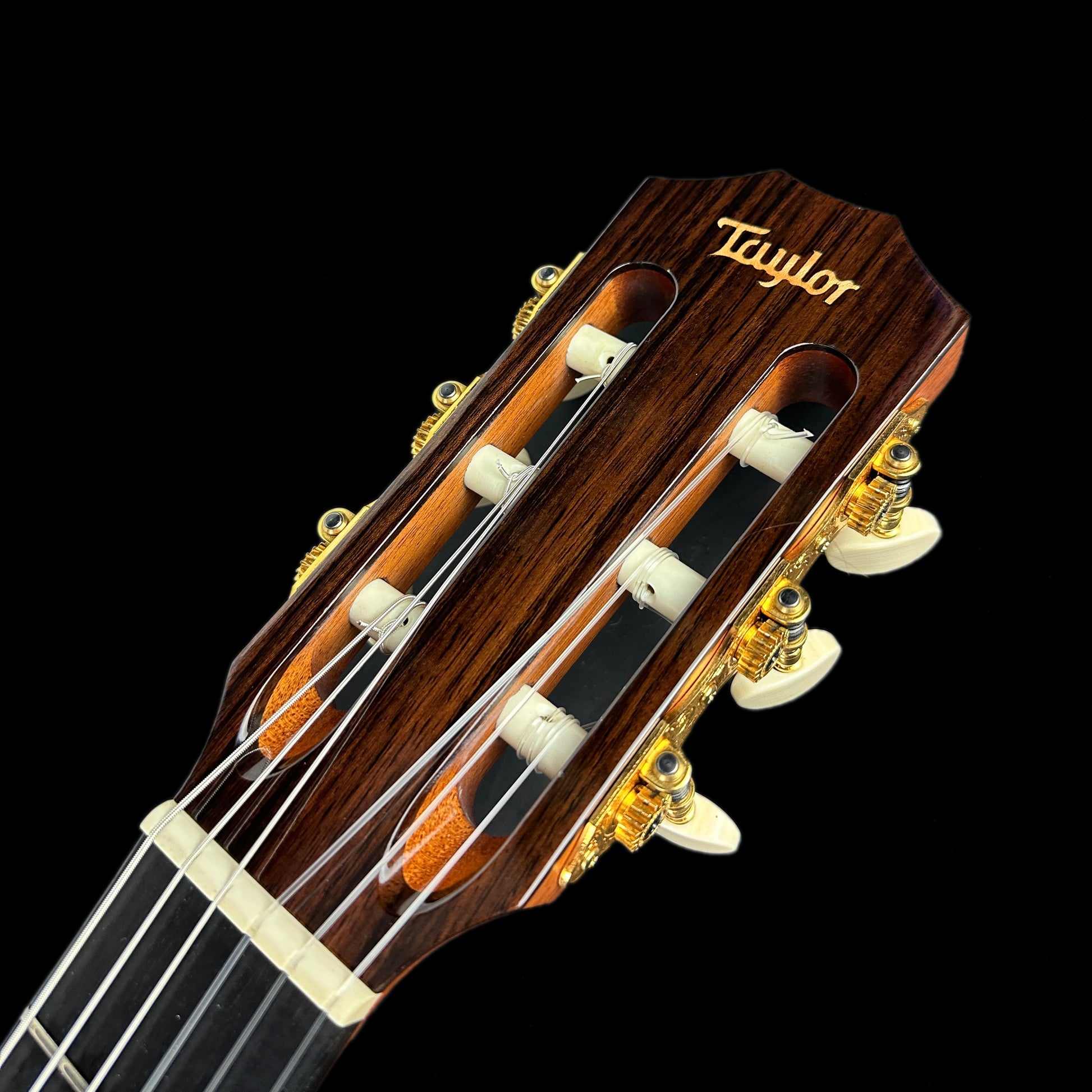 Front of headstock of Used 2004 Taylor NS72-CE.