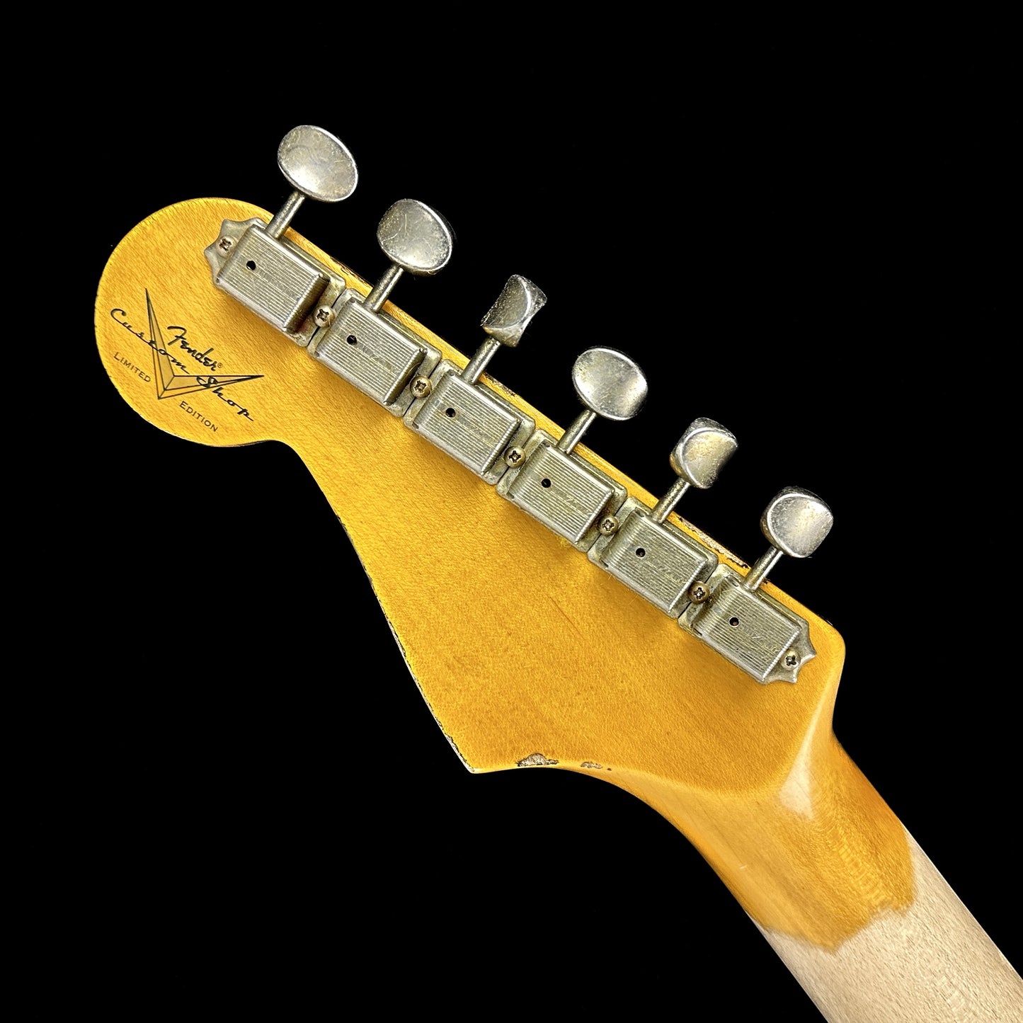 Back of headstock of Fender Custom Shop Limited Edition '62 Strat Heavy Relic Aged Black Over 3 Color Sunburst.