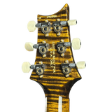 Guitar headstock with tortoiseshell finish and white tuning pegs on a white background