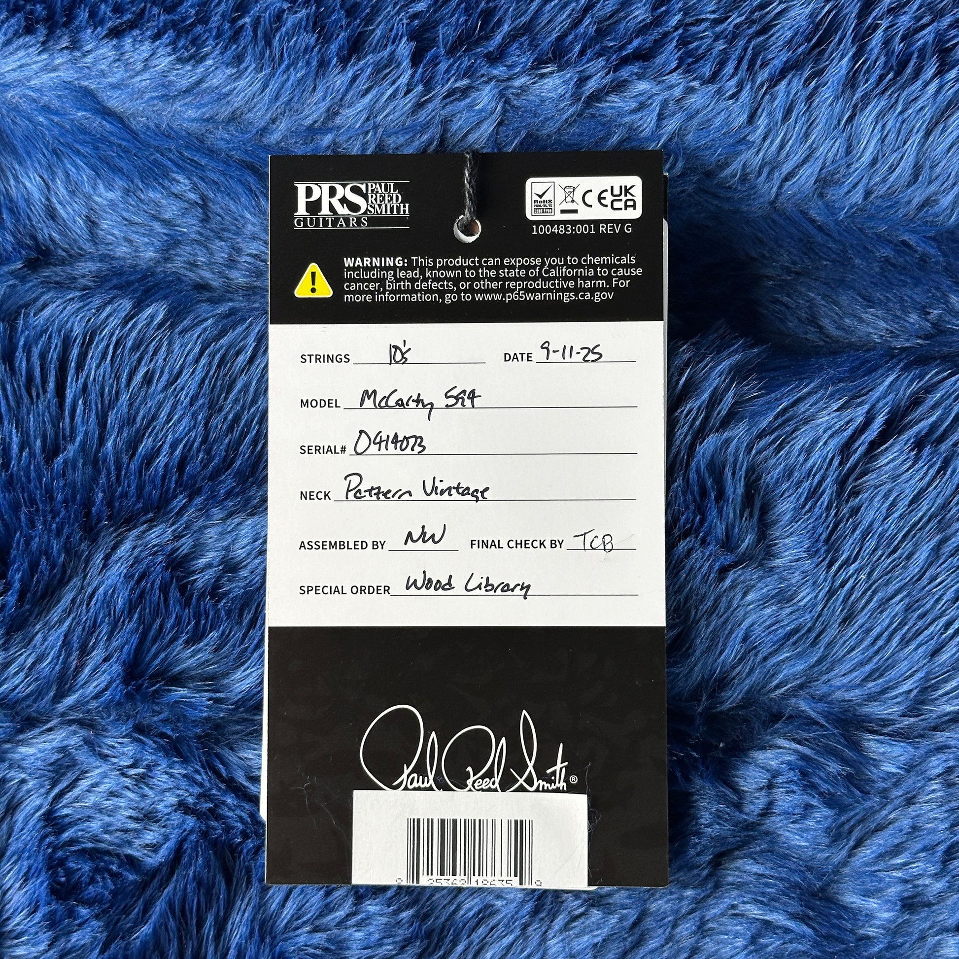 PRS guitar label on a blue textured background