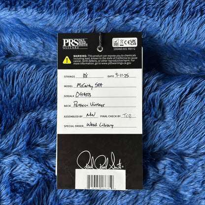 PRS guitar label on a blue textured background