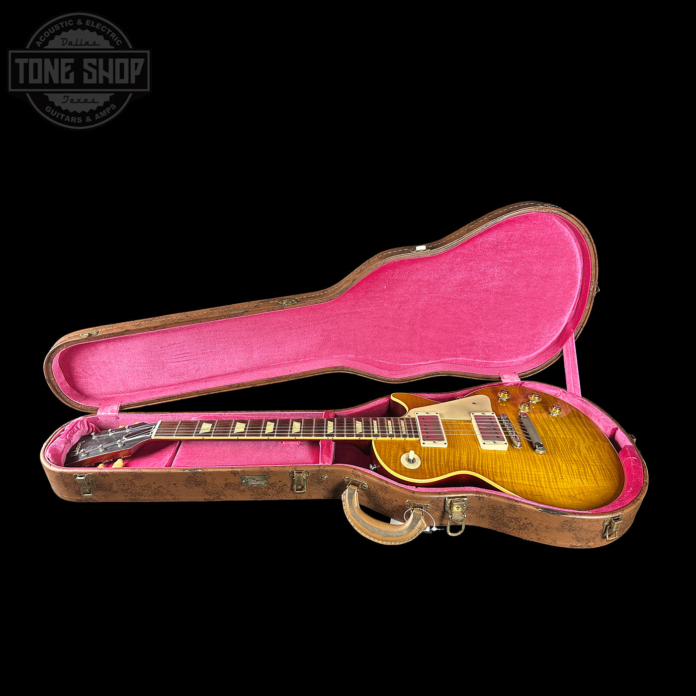 Gibson Les Paul guitar in a pink-lined case with 'Tone Shop' logo.