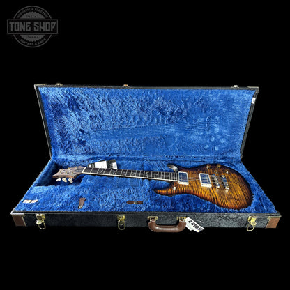 Guitar in a blue-lined case with 'Tone Shop' logo.